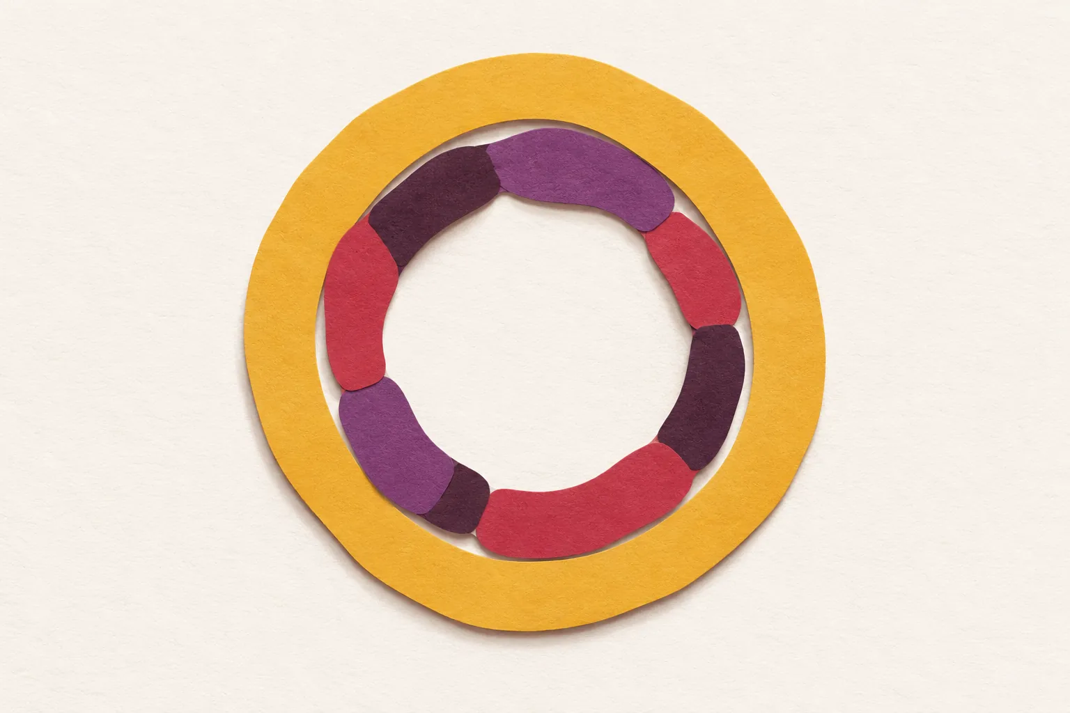 A wobbly ring of cherry and plum paper segments of different lengths, held inside a wider mustard band, on cream paper.