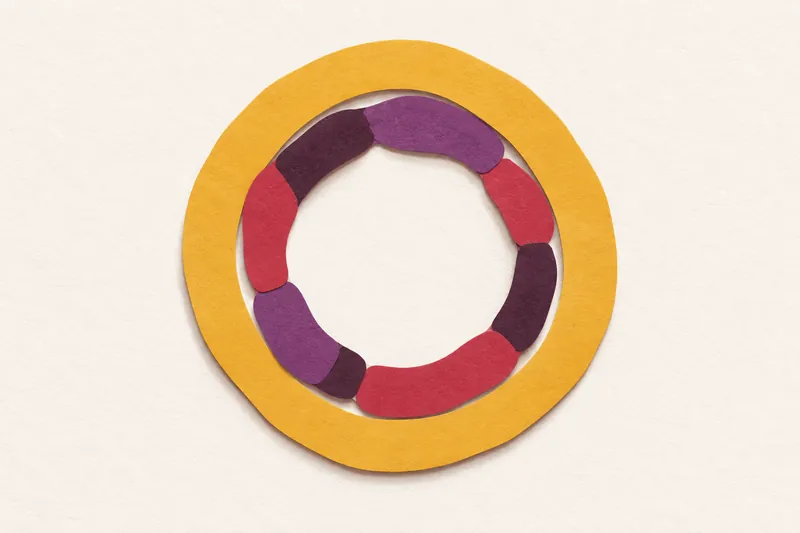 A wobbly ring of cherry and plum paper segments of different lengths, held inside a wider mustard band, on cream paper.