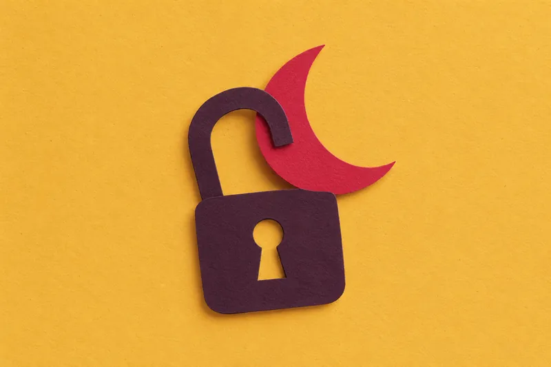 An aubergine cut-paper padlock with a cherry crescent moon slipping free of it, on mustard paper.